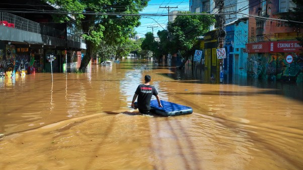 A resident walks through a flooded street as people are evacuated from their homes in Porto Alegre, Brazil.