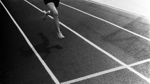 A runner crossing a finish line.