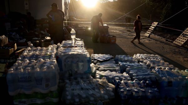 Volunteers gather water to distribute after Helene knocked out running water in North Carolina