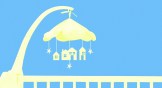 A baby crib mobile with stars and houses hanging from it.