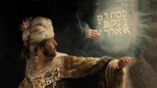 A detail from Rembrandt's painting of Belshazzar's Feast, showing the king astonished by the glowing hand and writing on the wall.