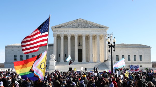 Supreme Court with an American flag and Transgender flag in front of it