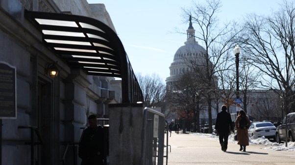 two people walking in DC in front of the Capitol building