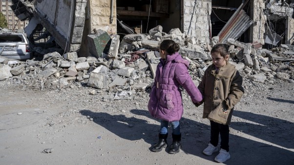 Children inspect the destroyed buildings after an Israeli attack in Lebanon.