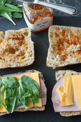 Rolls topped with pepper jelly, ham, cheese and arugula.