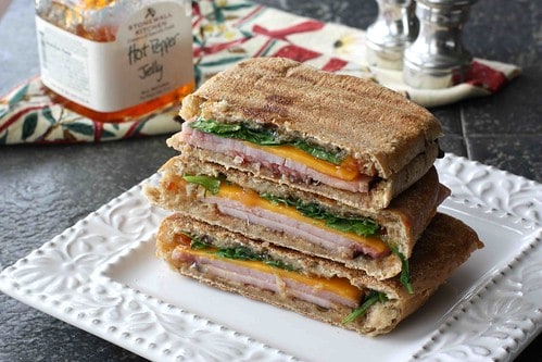 Toasted ham and cheese sandwich on a plate.