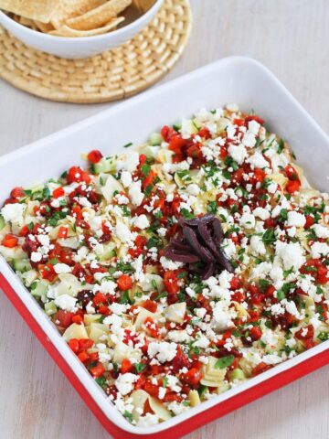 Put a fresh spin a classic appetizer recipe with this Healthy Mediterranean 7-Layer Dip. Perfect for afternoon snacking or game day! 49 calories and 1 Weight Watchers Freestyle SP #7layerdip #healthyappetizer