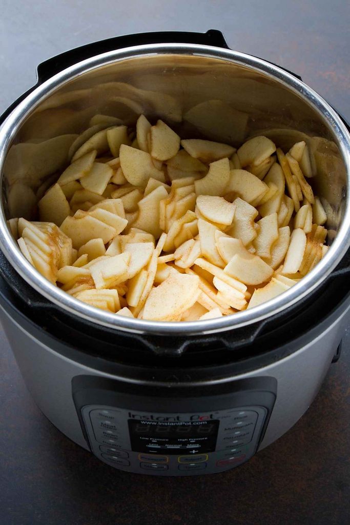 Peeled, cored and sliced apples in an Instant Pot pressure cooker.