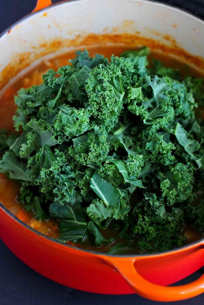 Chopped kale, ready to be mixed into healthy orzo soup.