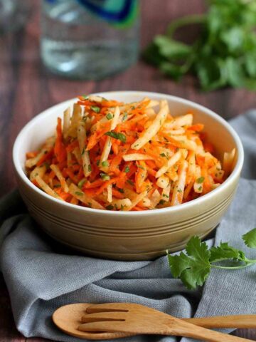 This refreshing jicama and carrot slaw recipe is fantastic served as a side dish or pile high on fish tacos. It's perfect for your Cinco de Mayo party, too! 54 calories and 1 Weight Watchers SP #slaw #jicama #weightwatchers #cleaneating