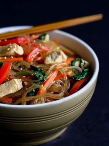 If you've never tried Korean glass noodles, now's the time! This sweet potato noodle recipe, called Japchae, is filled with chicken, vegetables & tons of flavor! 284 calories and 7 Weight Watchers Freestyle SP #glassnoodles #japchae #weightwatchers