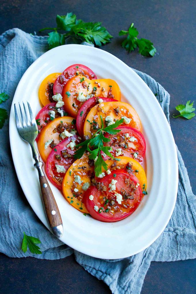 This sliced tomato salad is drizzled with an easy shallot balsamic vinaigrette. The perfect balance of sweet and savory! 86 calories and 3 Weight Watchers Freestyle SP #tomatoes #healthyrecipes #sidedish