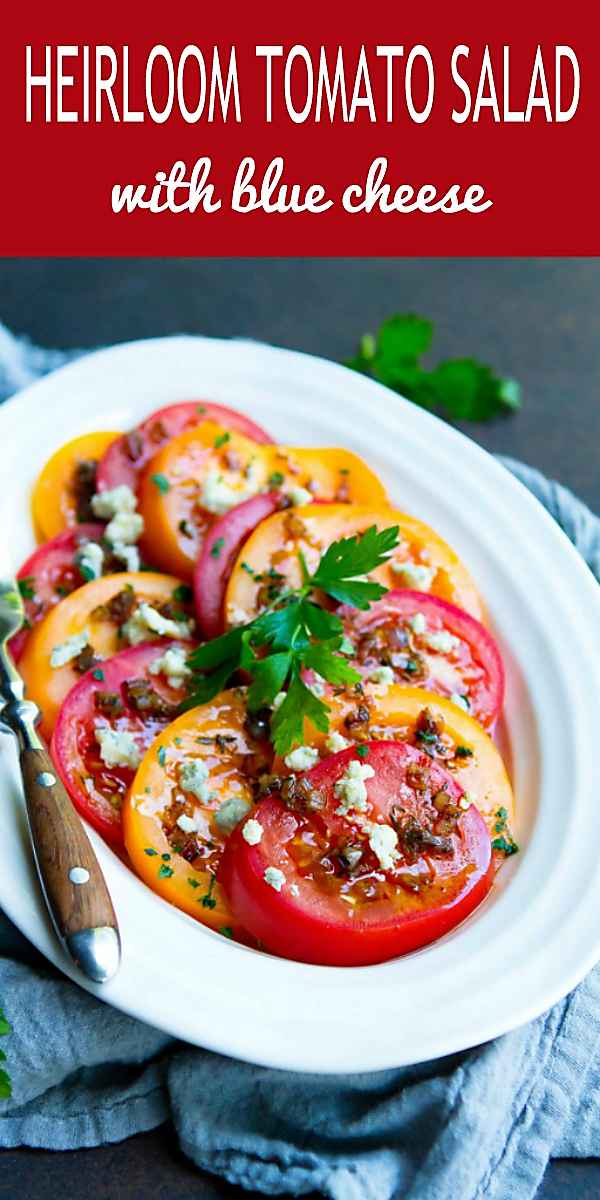 I can never stop eating this amazing Heirloom Tomato Salad. Topped with blue cheese crumbles and an easy vinaigrette. 86 calories and 3 Weight Watchers Freestyle SP #tomatorecipes #weightwatchers #healthyeating