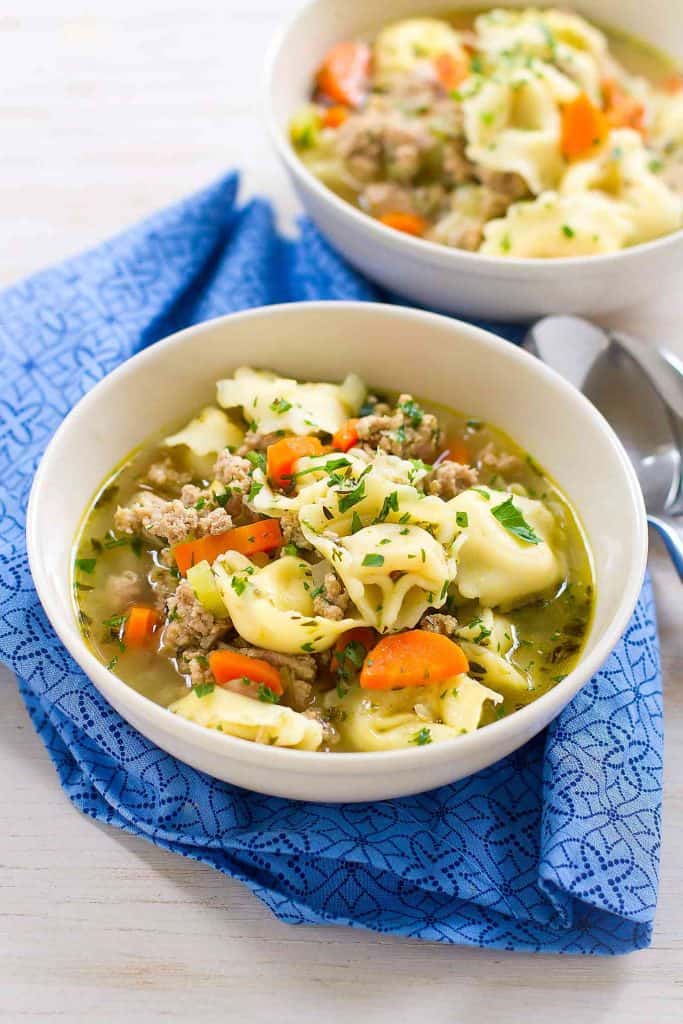 My family LOVES this Pesto Turkey Tortellini Soup recipe! And really, you can never have enough 30 minute recipes in your arsenal. 230 calories and 4 Weight Watchers SP | Ground Turkey | Stovetop | Easy | Healthy | 30 Minute Meal | Recipes | Broth #tortellinisoup #30minutemeals #easydinnerrecipes #souprecipes #healthysoups #weightwatchers #smartpoints