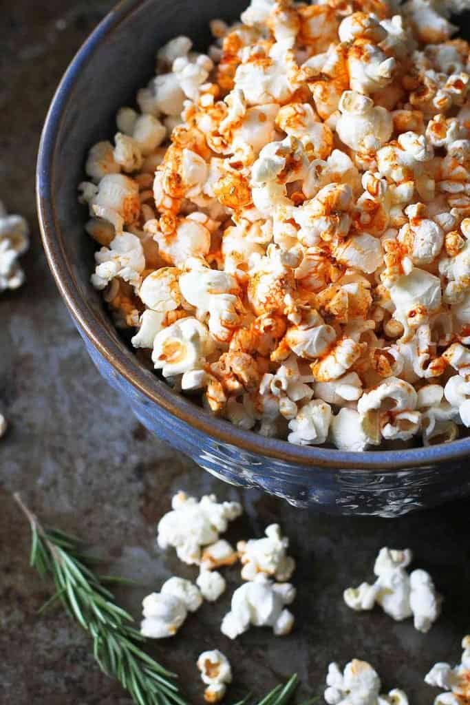 Popcorn topped with paprika olive oil, in a large blue bowl. 