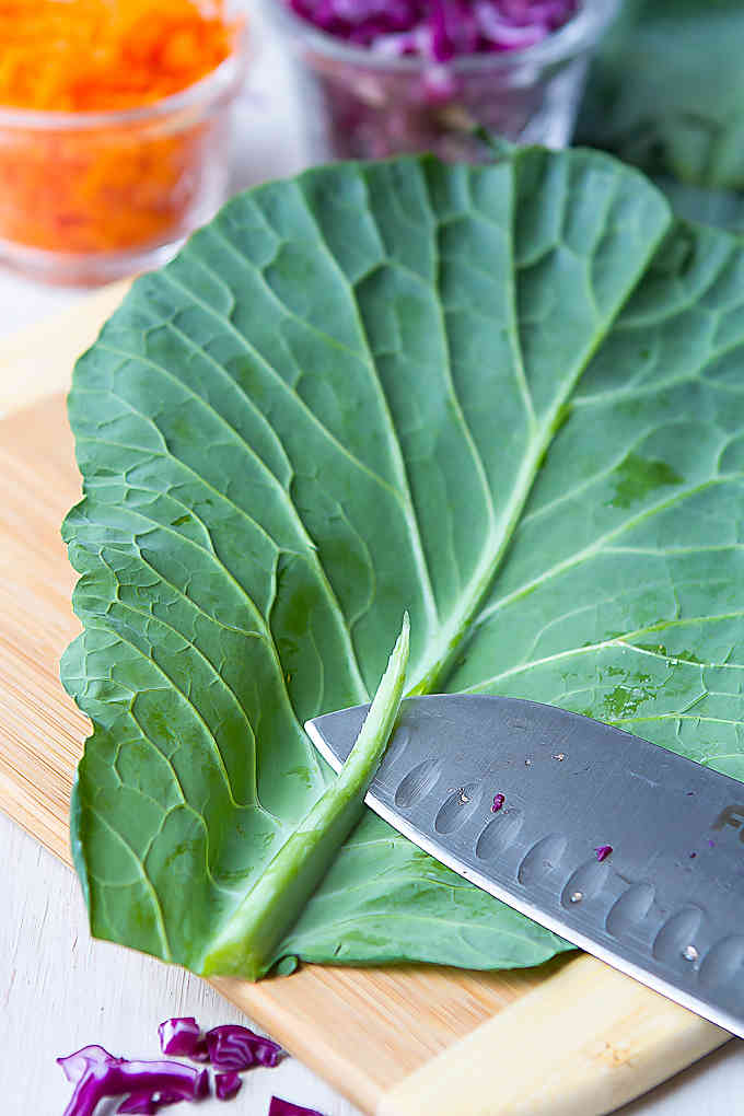 Trimming the stem of a collard green leaf.