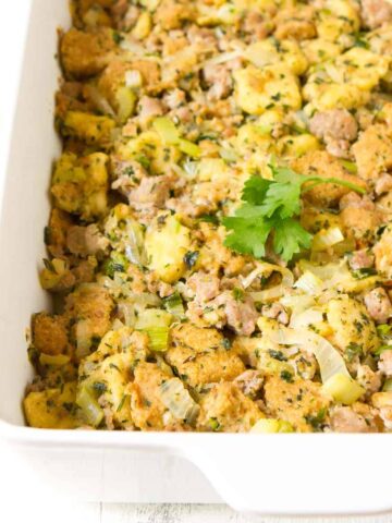 Sausage stuffing in a white baking dish.