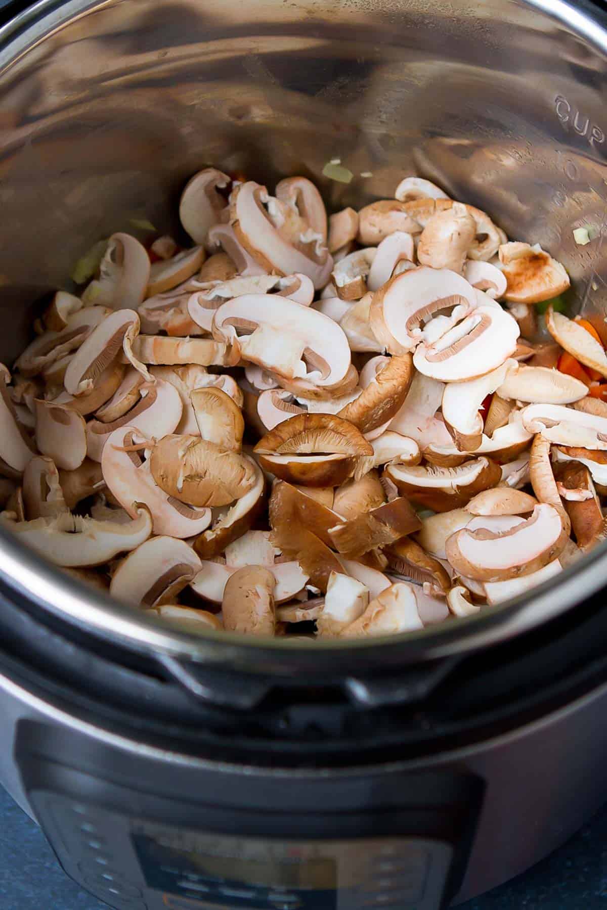 Sliced crimini and shiitake mushrooms in the Instant Pot pressure cooker.