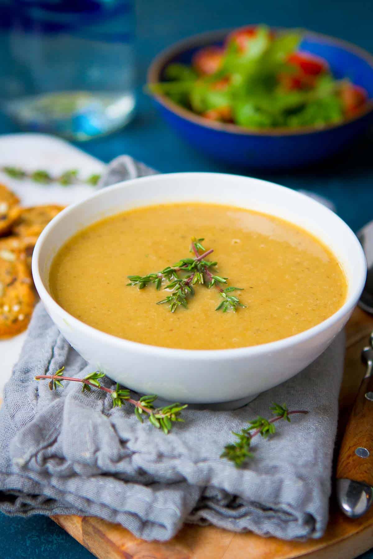 Vegan cream of mushroom soup in a white bowl, resting on a gray napkin.