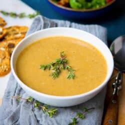 Vegan cream of mushroom soup in a white bowl, resting on a gray napkin.