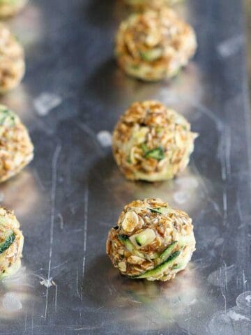 Zucchini oat bites on a baking sheet.