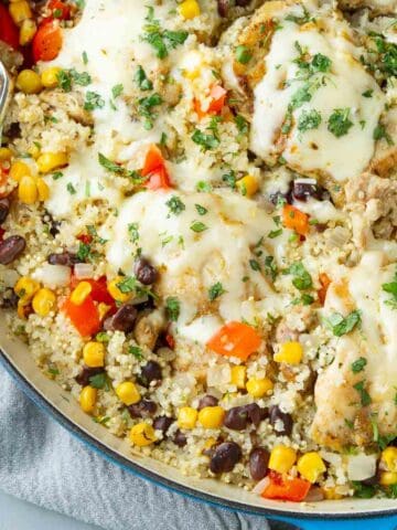 One pot meal in a skillet with chicken, quinoa, beans and vegetables.