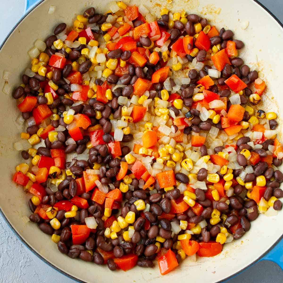 Black beans, corn and chopped red bell pepper in a large skillet.