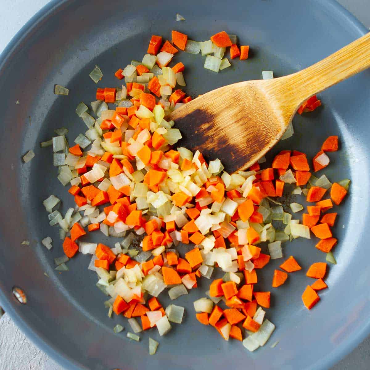 Chopped and carrots in a nonstick skillet.