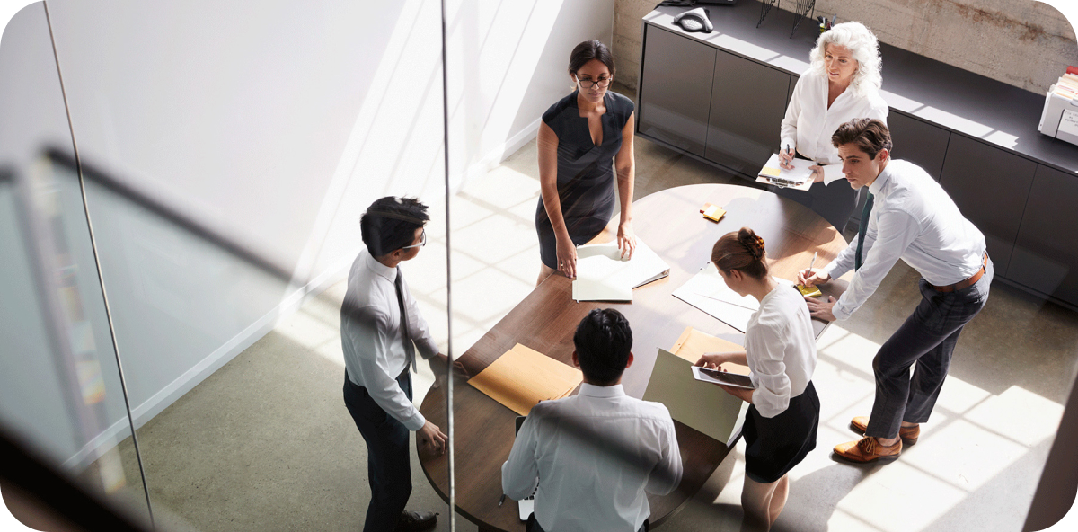 Group of employees filing papers during an important meeting