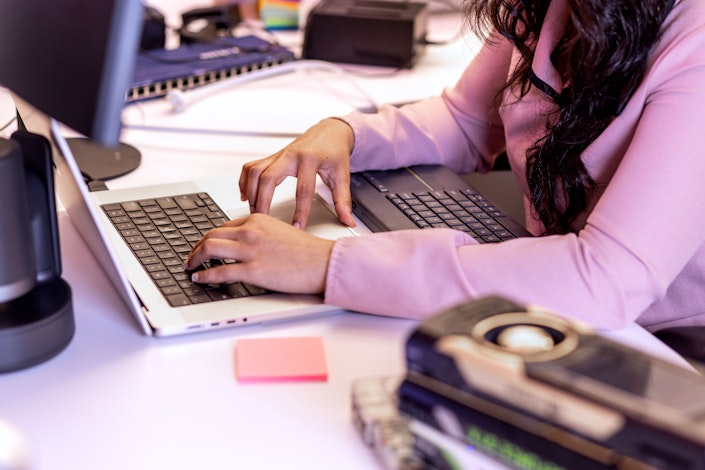 A closeup of an Ai2 team member's hands typing on a laptop.