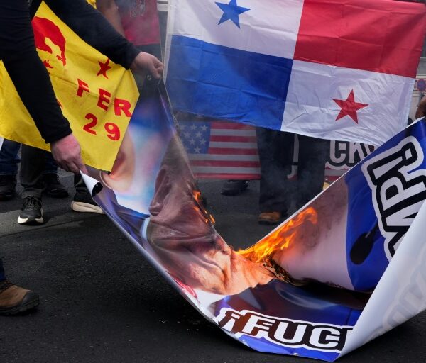 Demonstrators burn Donald Trump's image following his threat to demand control of the Panama Canal be returned to Washington, on December 24, 2024, in Panama City, Panama