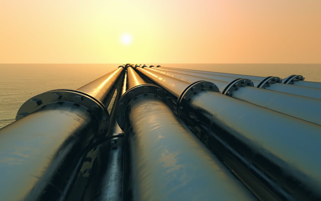 Tubes running in the direction of the setting sun. Pipeline transportation is most common way of transporting goods such as Oil, natural gas or water on long distances.