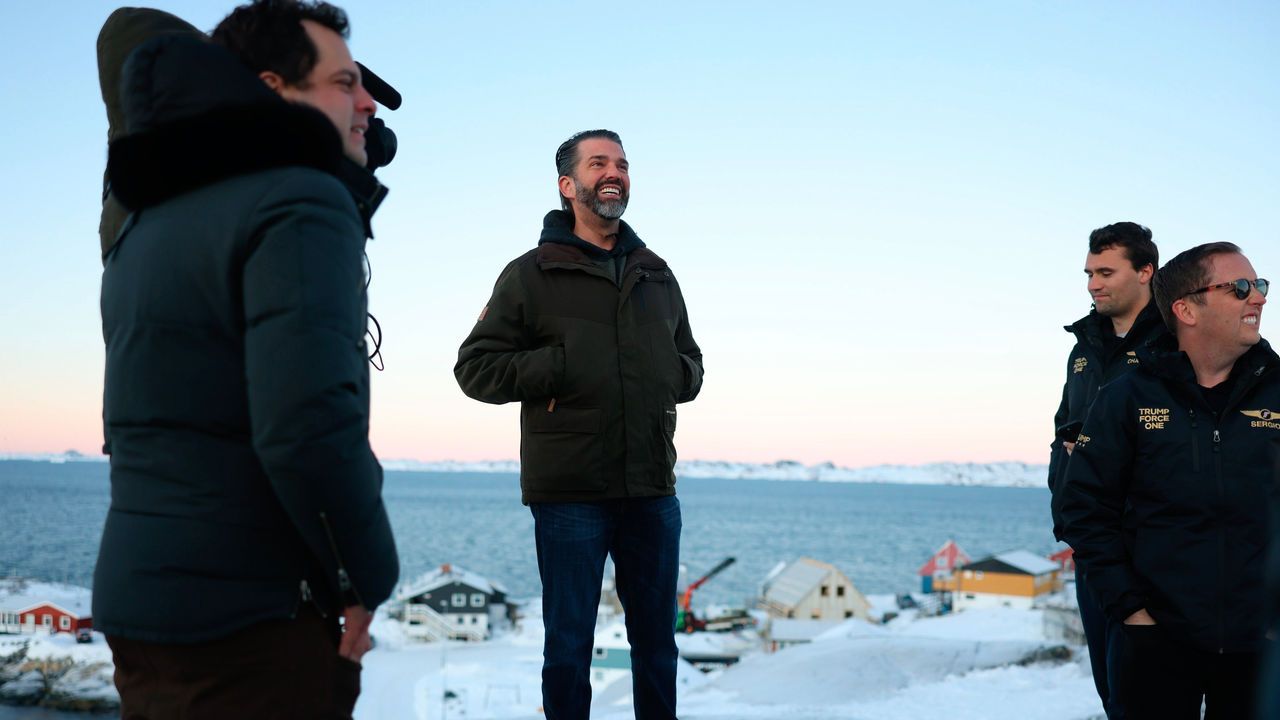 Donald Trump Jr., center, smiles after arriving in Nuuk, Greenland.