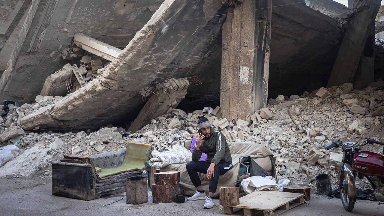 A man sits in front of a destroyed building in Daraya suburb on December 25, 2024 in Damascus, Syria