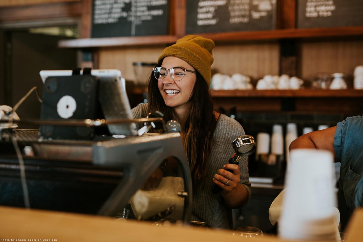 Smiling workers in a coffe. Photo by Brooke Cagle on Unsplash