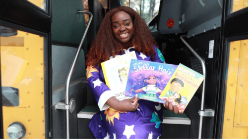 Event creator sits on steps of school bus to promote event