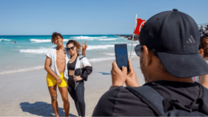 Performer poses for photo on beach