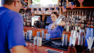 Event staff pours drink for customer