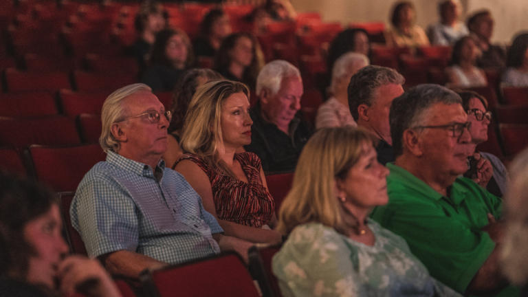 people sitting in crowd