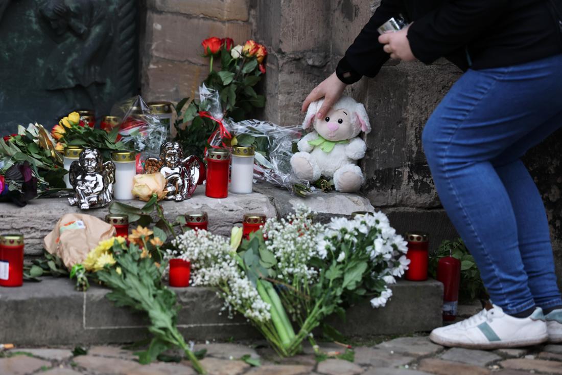 Eine Frau legt am Gedenkort an der Johanniskirche in Magdeburg ein Plüschtier nieder. Mehrere Menschen waren bei einem Anschlag auf dem Weihnachtsmarkt am Freitagabend ums Leben gekommen.