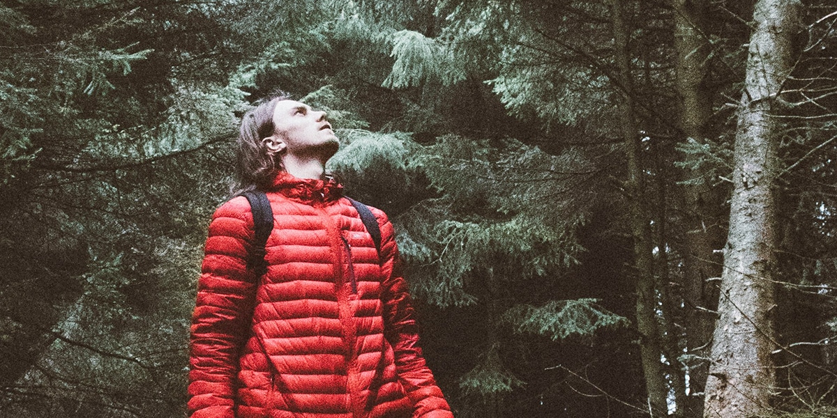 young hiker looking up into the sky