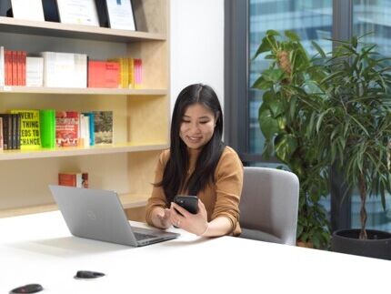 A woman works at her computer.