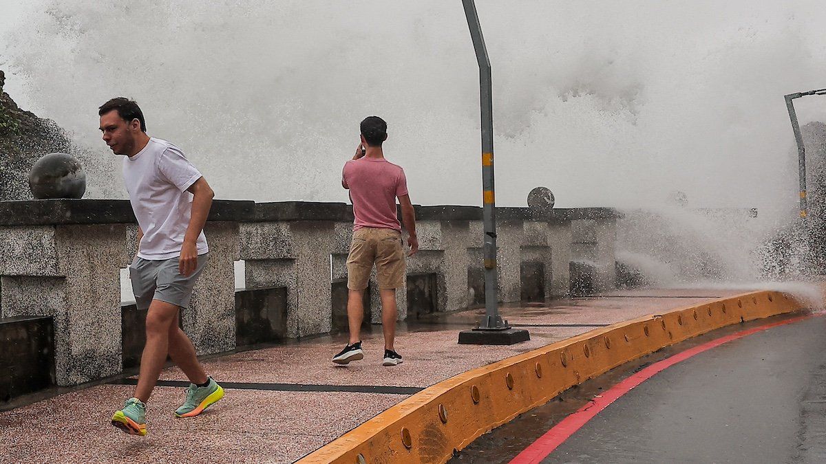 ​A person takes photos of the waves as Typhoon Krathon approaches in Kaohsiung, Taiwan October 2, 2024. 