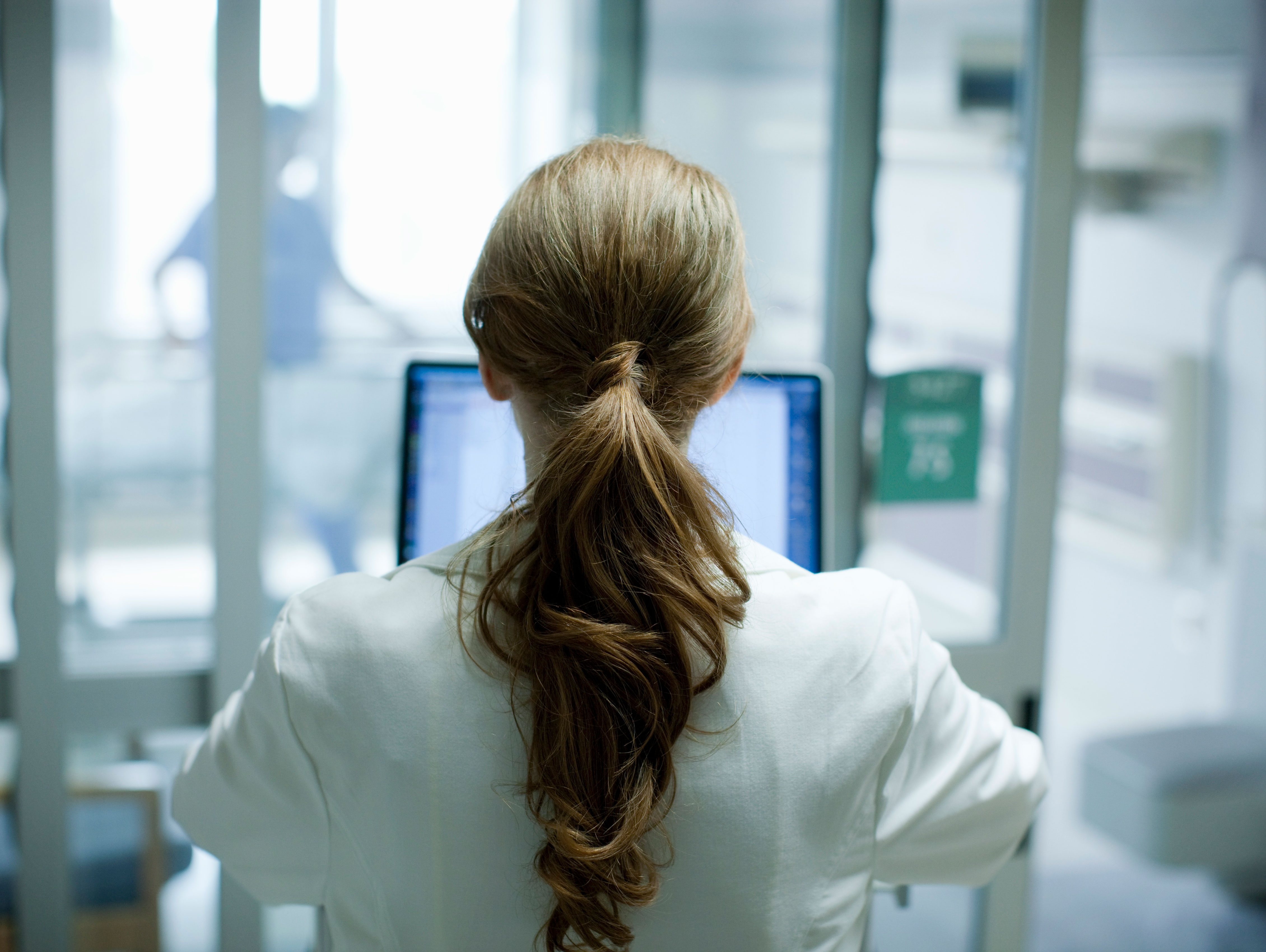 Doctor facing a computer screen