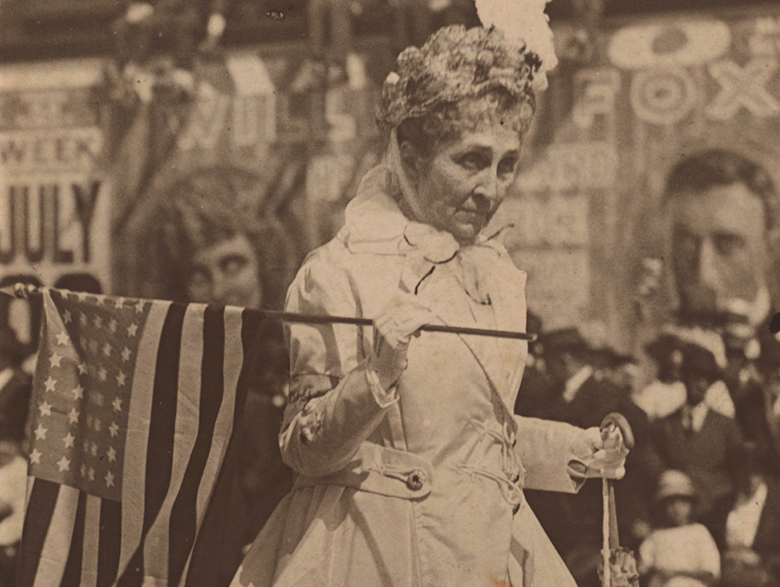 Phoebe Apperson Hearst marches in a local San Francisco parade holding a flag