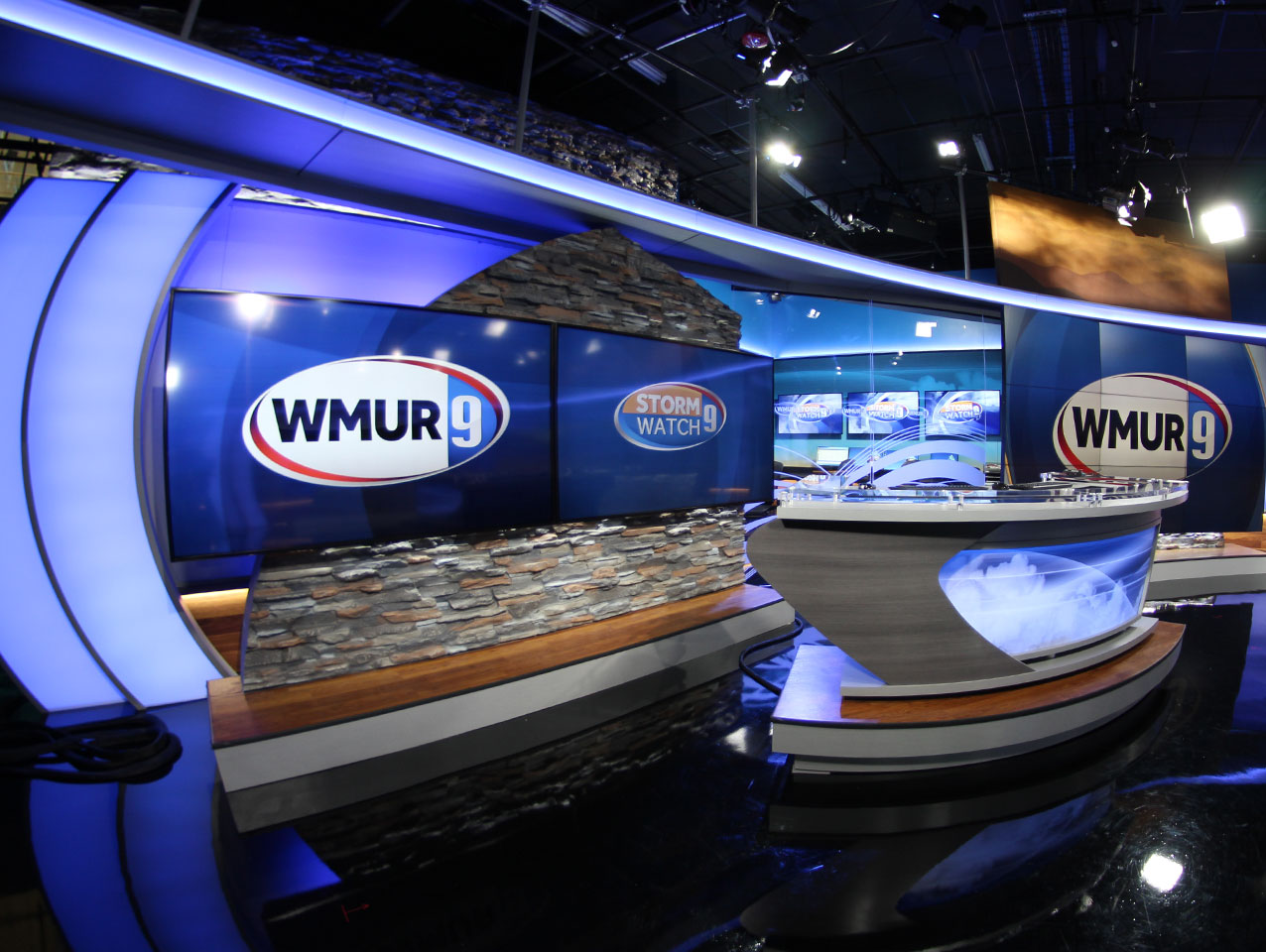 WMUR newsdesk with screens with WMUR logo