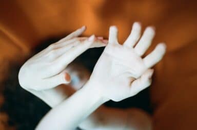 A woman's hands intertwined above her head, embodying the challenges of borderline personality disorder (BPD) symptoms.