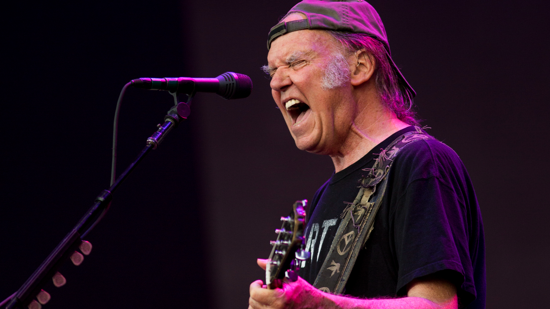 Neil Young performs on stage in the U.K. in 2014.