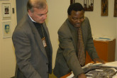 An IAEA inspector views a DPRK map with Mr. Chitumbo (right), who heads the IAEA Safeguards Operations Division for the Asia and Pacific region. (Credit: Hansen/IAEA) 