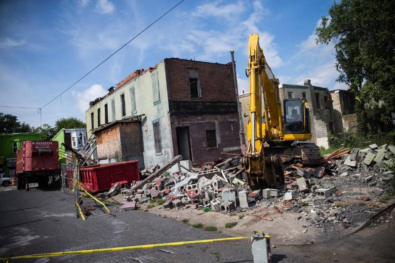 A building is demolished on August 22, 2013 in the Parkside neighborhood of Camden, New Jersey.